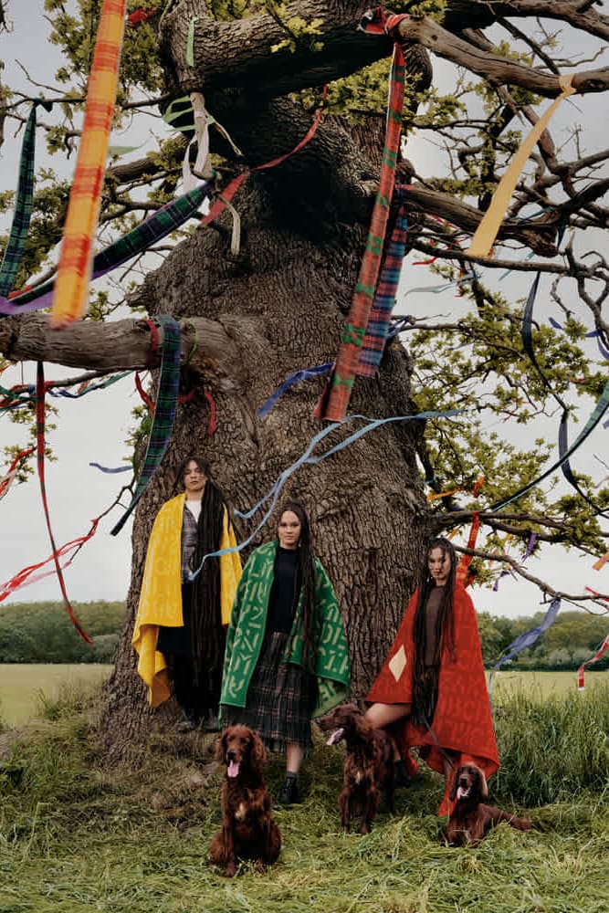 two twins posing together in grassy forest sharing a coat, byredo holiday, fragrance, makeup, perfume 